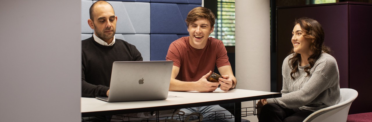people sitting around a table in a meeting room